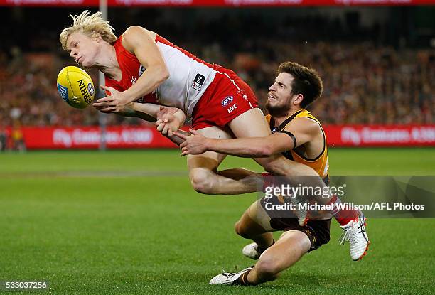 Isaac Heeney of the Swans is tackled by Ben Stratton of the Hawks during the 2016 AFL Round 09 match between the Hawthorn Hawks and the Sydney Swans...