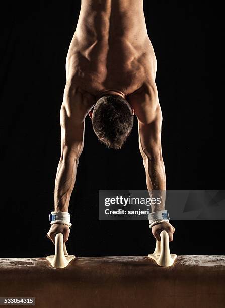 male gymnast doing handstand on pommel horse - artistisk gymnastik bildbanksfoton och bilder