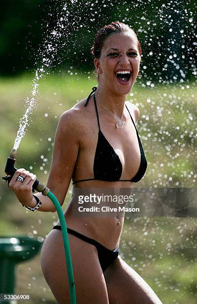 Glamour girls cool off in the heat during the practice session prior to qualifying for the Hungarian F1 Grand Prix at the Hungaroring on July 30,...
