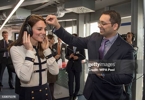 Mohammed-Asif Akhmad from BAE Systems places a microphone on Catherine, Duchess of Cambridge, patron of the 1851 Trust, as she tours the new 'Tech...