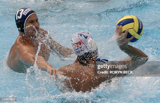 Petar Trbojevic of Serbia-Montenegro moves the ball past Hungary's Peter Biros during the Men's Water Polo gold medal match 30 July at the XI FINA...