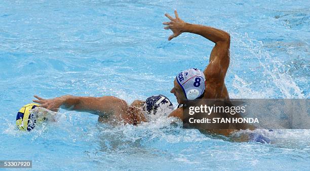Vladimir Gojkovic of Serbia-Montenegro vies for the ball with Hungary's Peter Biros during the Men's Water Polo gold medal match 30 July at the XI...