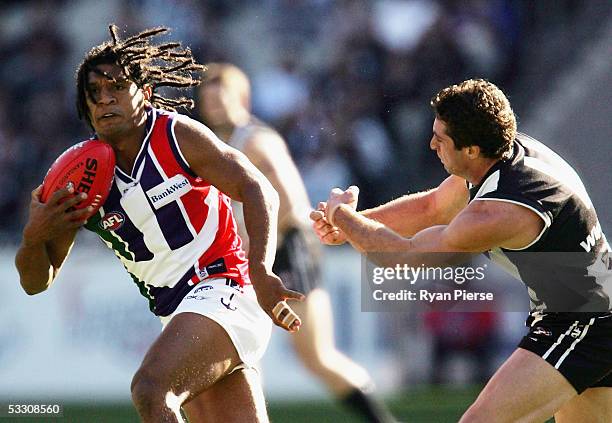 Troy Cook for the Dockers in action against Shane O'Bree for the Magpies during the round eighteen AFL match between the Collingwood Magpies and the...