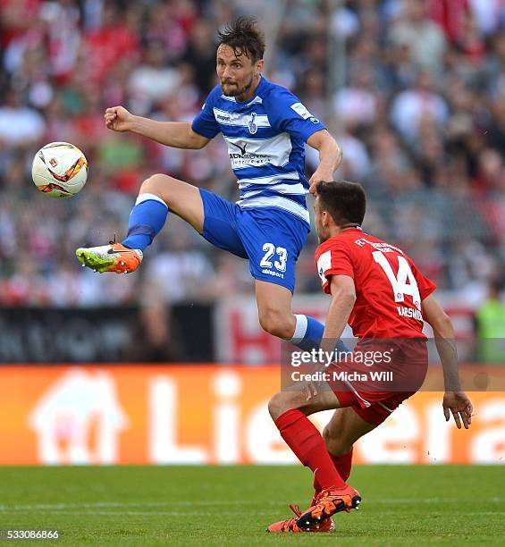 James Holland of Duisburg and Ionnis Karsanidis of Wuerzburg compete for the ball during the Second Bundesliga Play Off first leg match between...