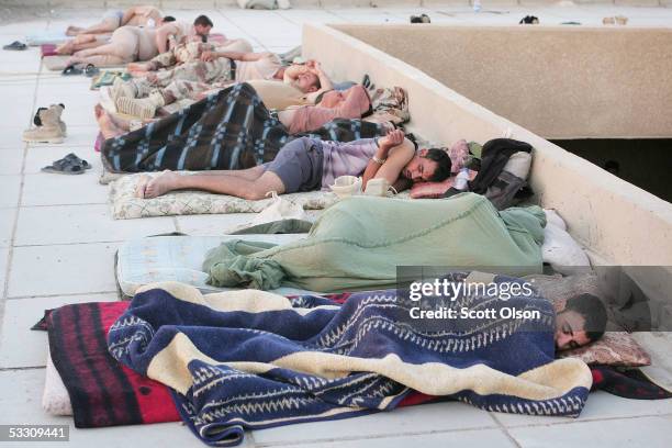Soldiers from the Iraqi Ground Forces Command sleep in the playground area of an abandoned school on July 31, 2005 in Fallujah, Iraq. Despite having...