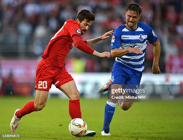 Daniel Nagy of Wuerzburg is challenged by James Holland of Duisburg during the Second Bundesliga Play Off first leg match between Wuerzburger Kickers...