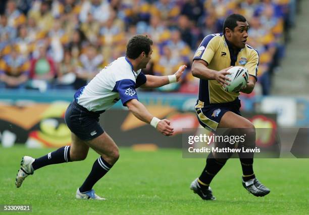 Ali Lauitiiti of Leeds beats the challenge from Jmaes Wynne of Toulouse during the Powergen Challenge Cup semi-final match between Leeds Rhinos and...