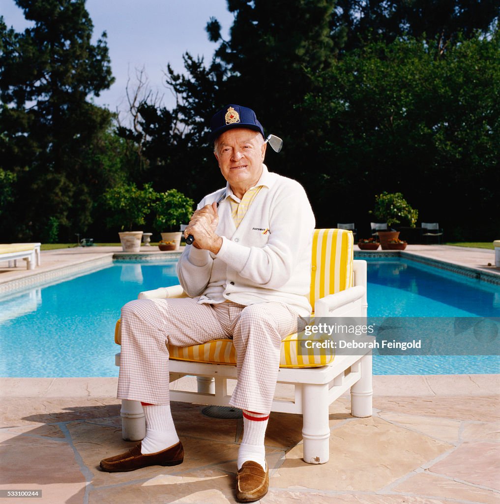 Bob Hope with Golf Club by Swimming Pool