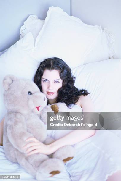 Deborah Feingold/Corbis via Getty Images) Actress Mia Kirshner with Teddy Bear