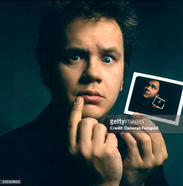 Deborah Feingold/Corbis via Getty Images) Tim Robbins Holding Picture of Himself