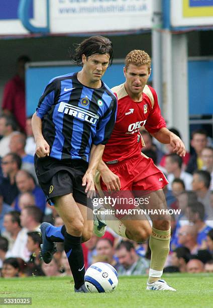 Portsmouth, UNITED KINGDOM: Santiago Solari of Internazionale Milan holds off the challenge of Portsmouth's Andy Griffin in the pre season friendly...
