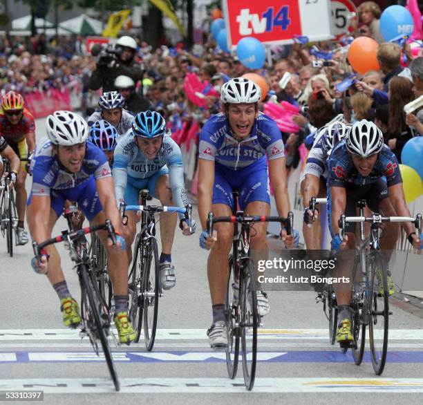 The winning cyclists cross the line in a photo finish with Filippo Pozzato first, and Luca Paolini from Italy second and Allan Davis from Italy third...
