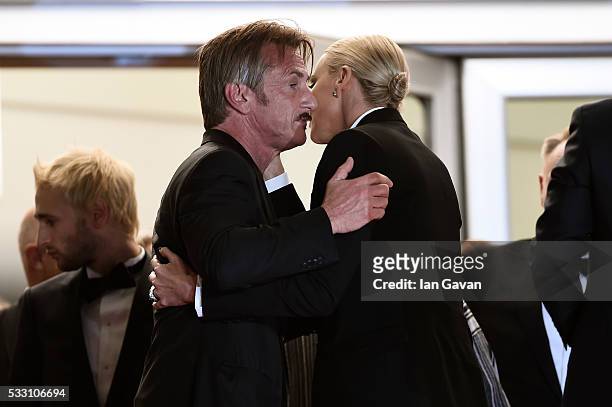 Sean Penn and Charlize Theron embrace each other as they leave the screening of "The Last Face" at the annual 69th Cannes Film Festival at Palais des...
