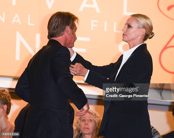 Sean Penn embraces Charlize Theron as they attend the screening of 'The Last Face' at the annual 69th Cannes Film Festival at Palais des Festivals on...