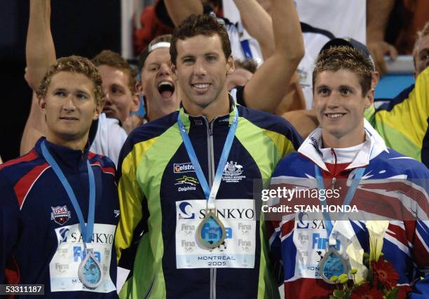 Grant Hackett of Australia stands with David Davies of Great Britain and Larsen Jensen of the USA following the Men's 1500M Freestyle final 31 July,...