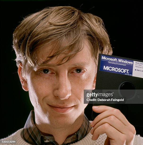 Deborah Feingold/Corbis via Getty Images) Bill Gates, CEO of Microsoft, holds a Windows 1.0 floppy disk soon after its release.