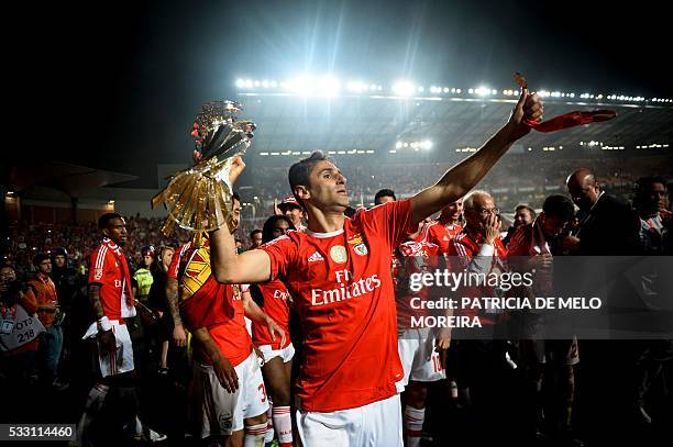 Benfica's Brazilian forward Jonas Oliveira holds the trophy as he celebrates after winning the Portuguese League Cup final football match CS Maritimo...