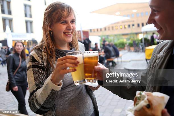 Customers sample beers at the Handgemacht craft beer festival in the Kulturbrauerei on May 20, 2016 in Berlin, Germany. During the 500th anniversary...