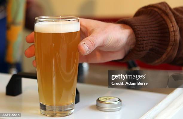 Customer samples a beer at the Handgemacht craft beer festival in the Kulturbrauerei on May 20, 2016 in Berlin, Germany. During the 500th anniversary...