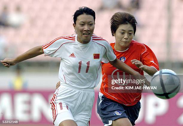 China's Women's National Team player Chen Yanhong fights for thye ball with South Korea's Lee Ji-Eun during their East Asian Football Championship...