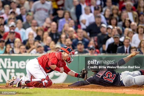 Francisco Lindor of the Cleveland Indians avoids the tag of Christian Vazquez of the Boston Red Sox as he scores during the third inning of a game on...
