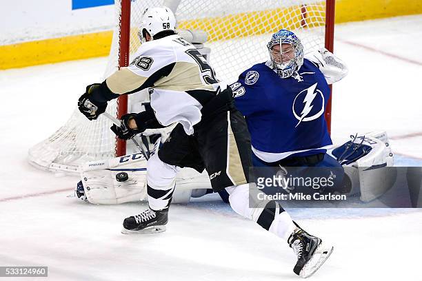 Andrei Vasilevskiy of the Tampa Bay Lightning makes a kick save against Kris Letang of the Pittsburgh Penguins during the first period in Game Four...