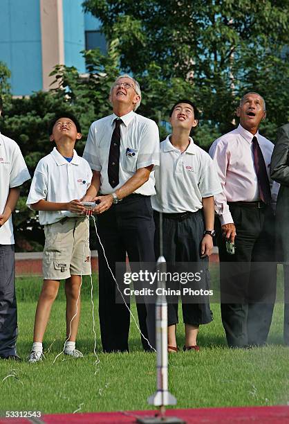 Retired U.S. Astronauts Charles F. Bolden and Charles M. Duke fly rocket models with Chinese children as they visit the Shanghai Children's Palace on...