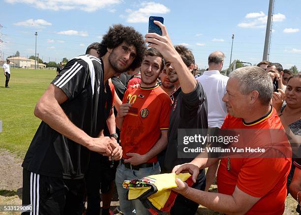 Marouane Fellaini of Belgium gives autographs after a training session of the National Soccer Team of Belgium as part of the training camp prior to...