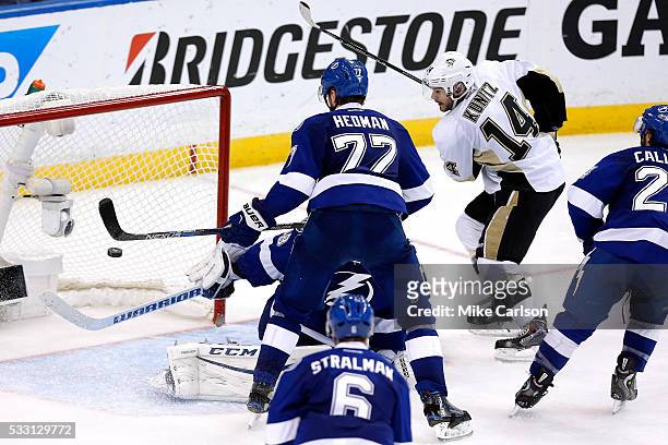 Chris Kunitz of the Pittsburgh Penguins scores the third goal against Andrei Vasilevskiy of the Tampa Bay Lightning during the third period in Game...