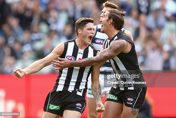 Jack Crisp of the Magpies is congratulated by Jesse White after kicking a goal during the round nine AFL match between the Collingwood Magpies and...