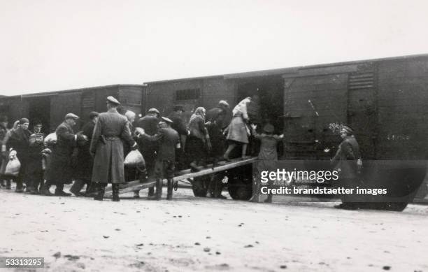 Holocaust: Deportation of Polish Jews in cattle carriages on "reloading point" in Warsaw. On the platform German soldiers. Photography. 1944....