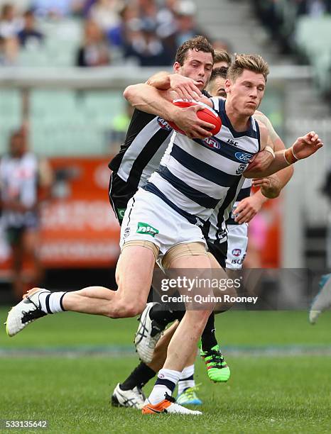 Mark Blicavs of the Cats is tackled by Jarryd Blair of the Magpies during the round nine AFL match between the Collingwood Magpies and the Carlton...