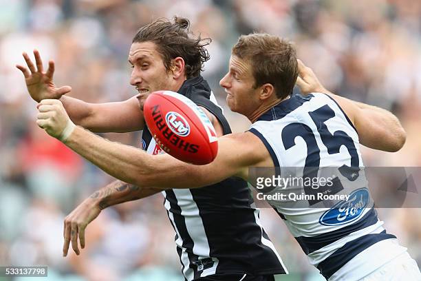 Lachie Henderson of the Cats spoils a mark by Jesse White of the Magpies during the round nine AFL match between the Collingwood Magpies and the...