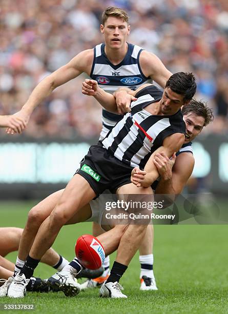 Scott Pendlebury of the Magpies is tackled by Tom Hawkins of the Cats during the round nine AFL match between the Collingwood Magpies and the Carlton...