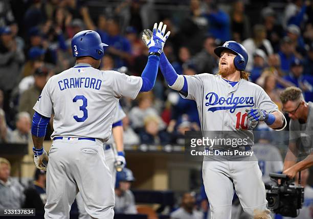 Justin Turner of the Los Angeles Dodgers, right, is congratulated by Carl Crawford after hitting a two-run home run during the eighth inning of a...