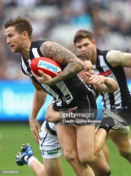 Jeremy Howe of the Magpies is tackled by Mitch Duncan of the Cats during the round nine AFL match between the Collingwood Magpies and the Carlton...