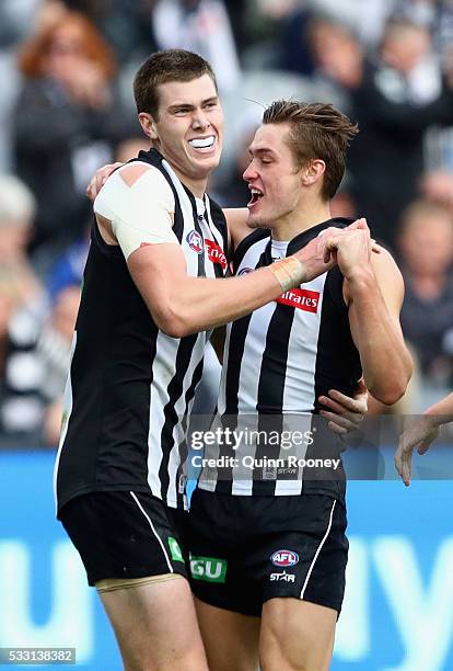 Mason Cox of the Magpies is congratulated by Darcy Moore after kicking a goal during the round nine AFL match between the Collingwood Magpies and the...