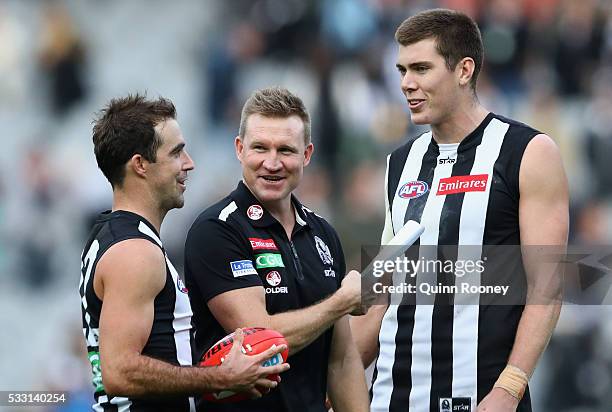 Steele Sidebottom, Nathan Buckley and Mason Cox of the Magpies have a laugh after winning the round nine AFL match between the Collingwood Magpies...