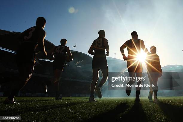 Power players run onto the field before the start of the round nine AFL match between the Port Adelaide Power and the West Coast Eagles at Adelaide...