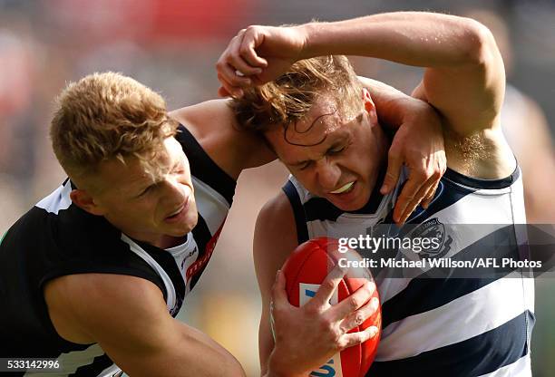 Mitch Duncan of the Cats is taken high by Adam Treloar of the Magpies during the 2016 AFL Round 09 match between the Collingwood Magpies and the...