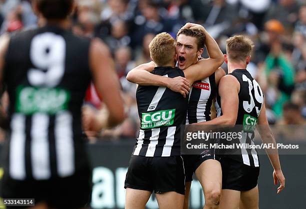 Adam Treloar, Darcy Moore and Ben Crocker of the Magpies celebrate during the 2016 AFL Round 09 match between the Collingwood Magpies and the Geelong...
