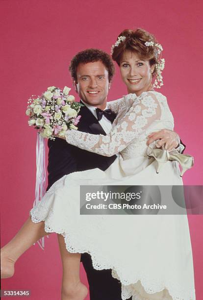 American actor Kevin Dobson and American actress Michele Lee pose in wedding outfits in a publicity portrait for the TV soap opera series 'Knots...