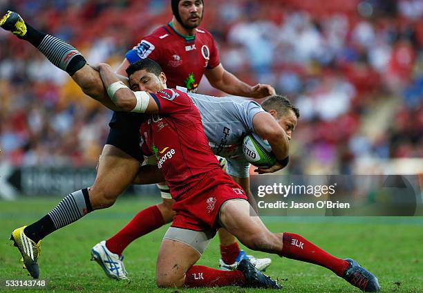 Anthony Faingaa of the reds tackles Riaan Viljoen of the sunwolves during the round 13 Super Rugby match between the Reds and the Sunwolves at...