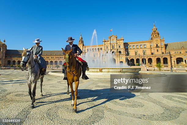 couple of riders in the square of spain in seville - feria bildbanksfoton och bilder