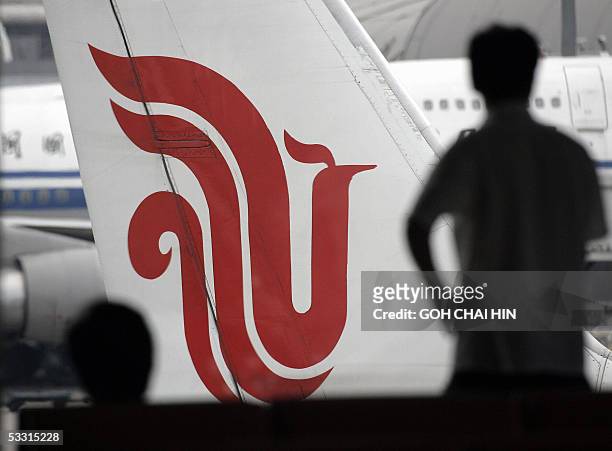 Passengers wait for their Air China flights at Beijing's Capital International Airport, 02 August 2005. Chinese airlines, following the lead of other...