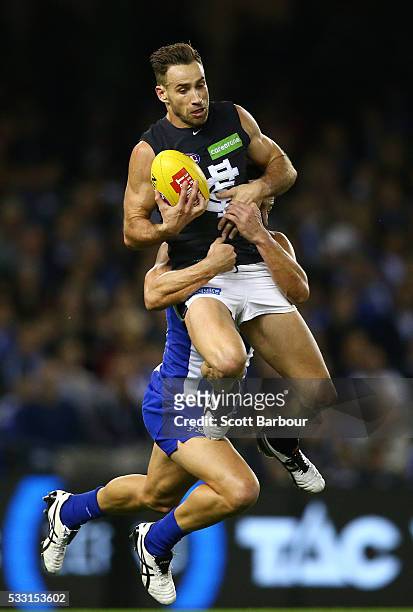 Andrew Walker of the Blues takes a mark in front of Robbie Tarrant of the Kangaroos during the round nine AFL match between the North Melbourne...