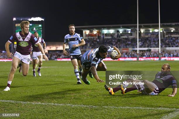 Sosaia Feki of the Sharks breaks the tackle of Brett Stewart of the Eagles to score a try during the round 11 NRL match between the Cronulla Sharks...