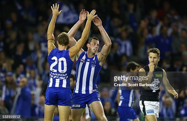 Todd Goldstein of the Kangaroos celebrates after kicking a goal with Drew Petrie of the Kangaroos during the round nine AFL match between the North...