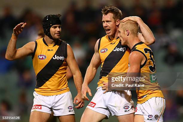 Trent Cotchin, Jack Riewoldt celebrate a goal by Steven Morris of the Tigers during the round nine AFL match between the Fremantle Dockers and the...