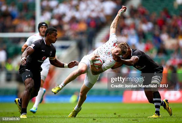 Ruaridh McConnochie of England is tackled by Osea Kolinisau of Fiji during the pool match between England and Fiji during day one of the HSBC London...